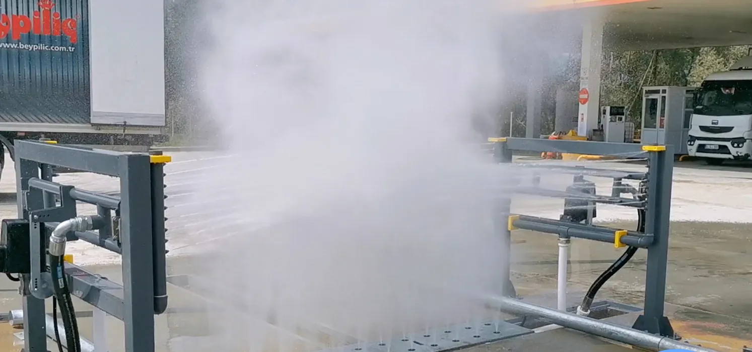Europe Makine chassis wash spraying across an underbody wash bay