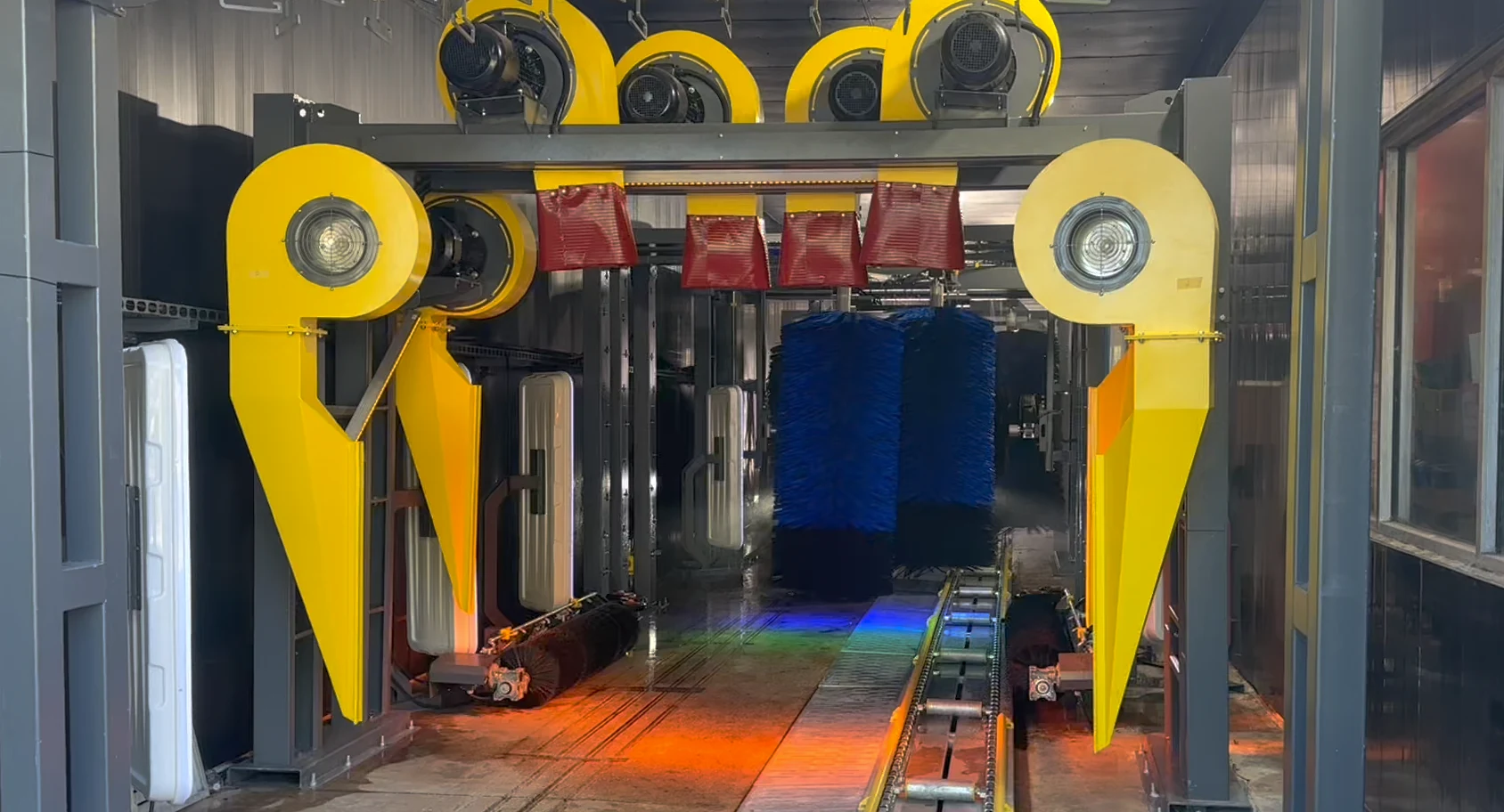 Front view into a Europe Makine conveyor tunnel with drying arches and brushes